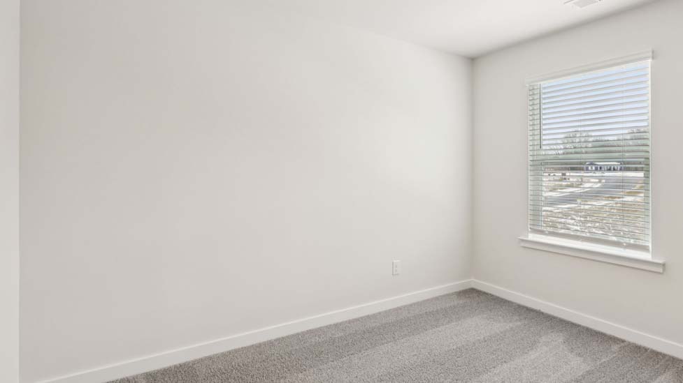 Carpeted bedroom with large window