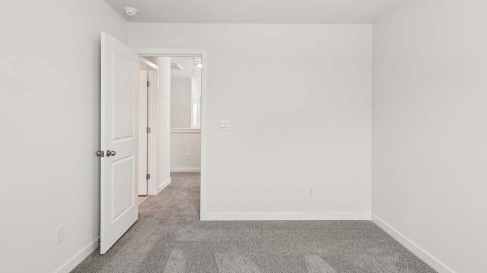 Carpeted bedroom with large window