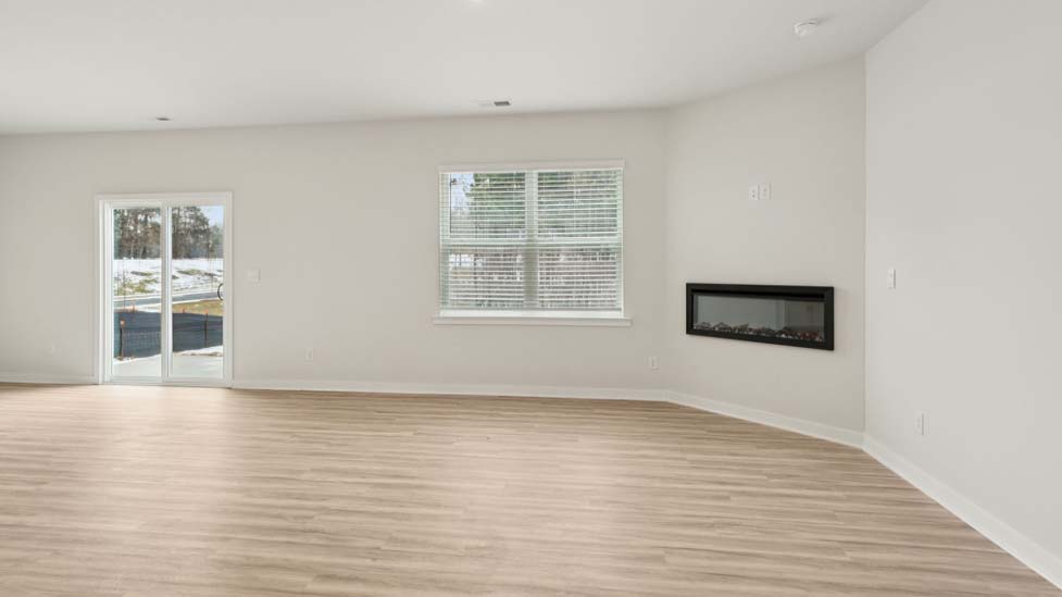 Living room with electric fireplace and large window