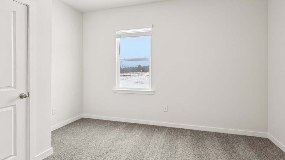 Carpeted bedroom with small window