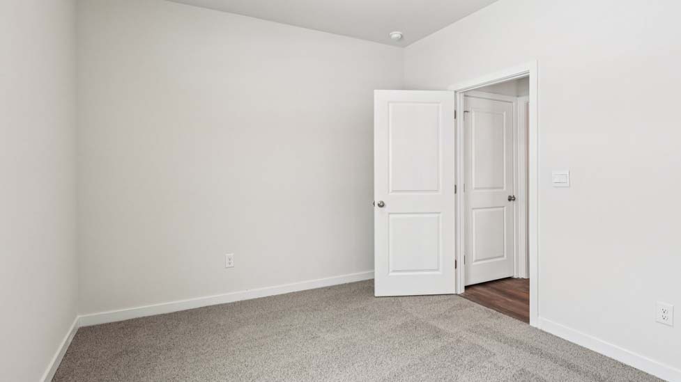 Carpeted bedroom with small window