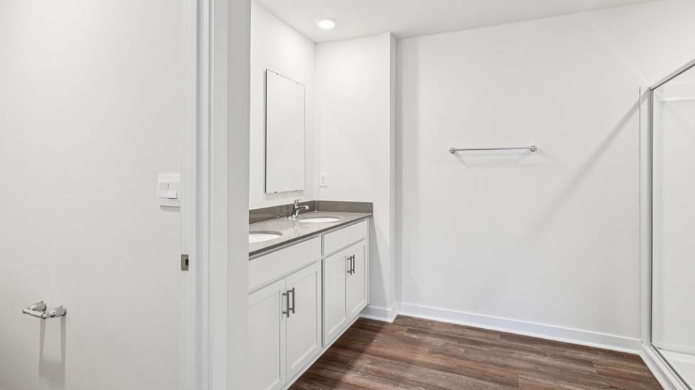 Primary bathroom with dual sink vanity, walk in shower attached to primary bedroom
