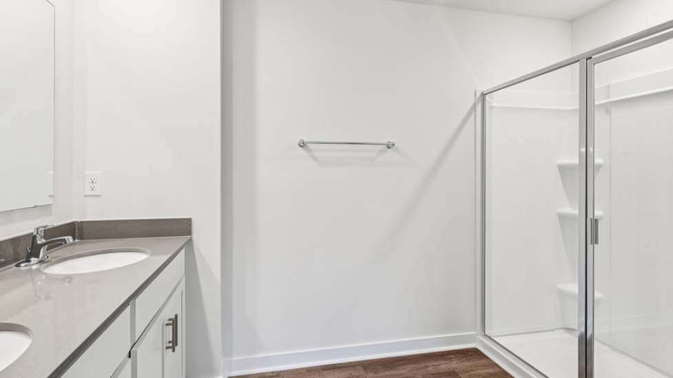 Primary bathroom with dual sink vanity, walk in shower attached to primary bedroom