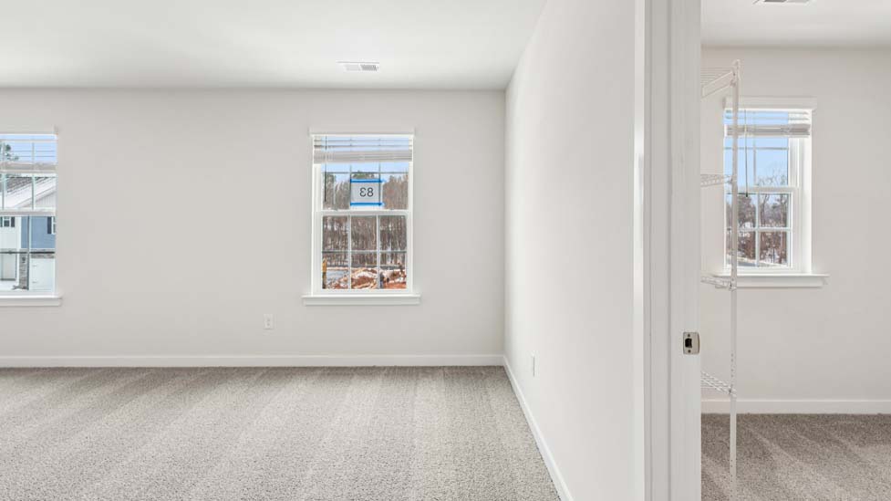 Carpeted bedroom with small window