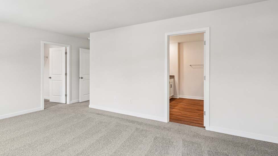 Carpeted bedroom with small window
