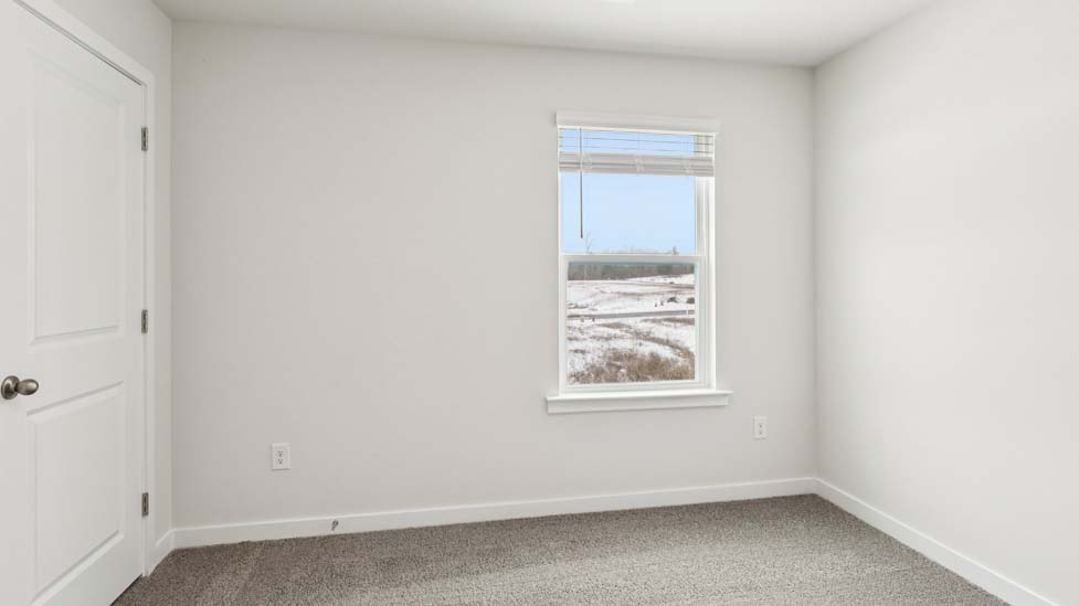 Carpeted bedroom with small window