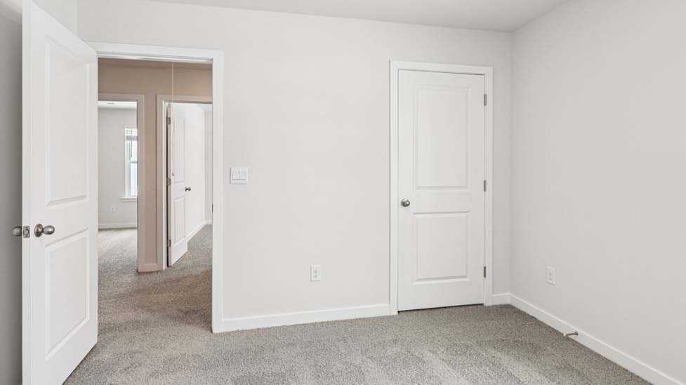 Carpeted bedroom with small window