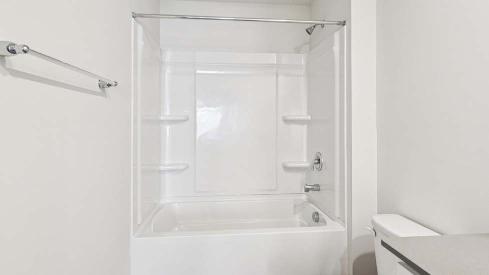 Bathroom with bathtub shower combo and double sink vanity