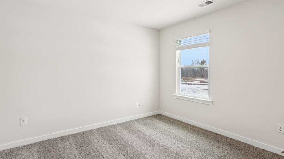 Carpeted bedroom with small window