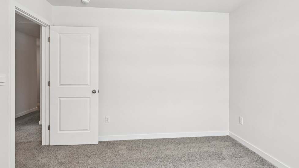 Carpeted bedroom with small window