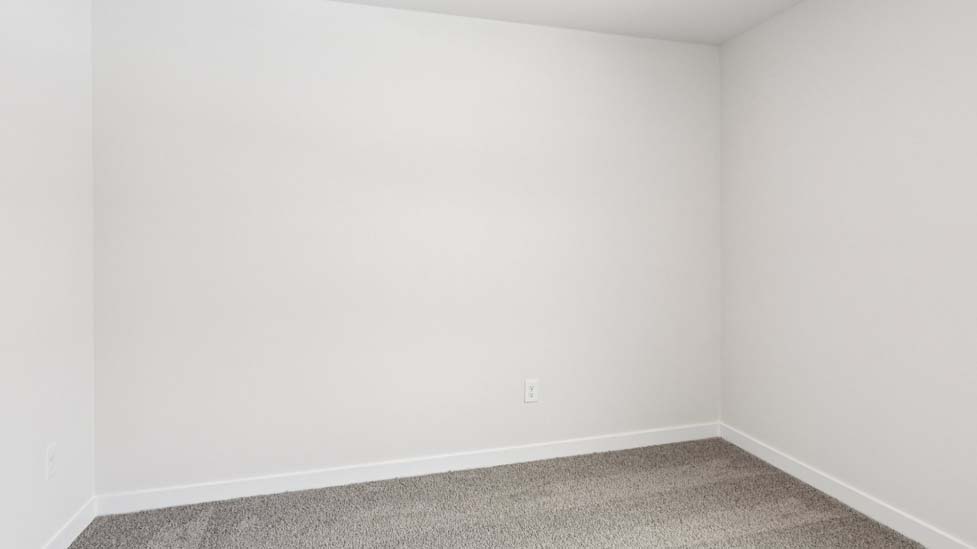 Carpeted bedroom with small window