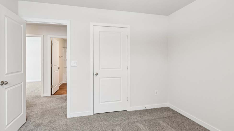 Carpeted bedroom with small window