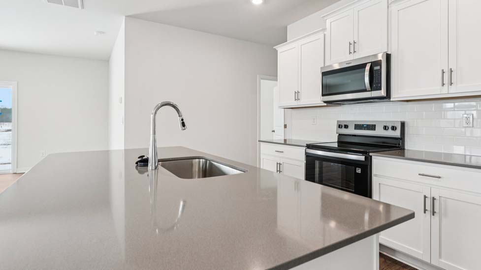 Kitchen and island with stainless steel appliances