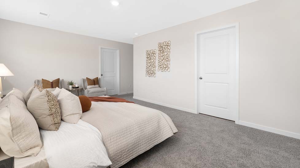 Primary bedroom, carpeted with two large windows
