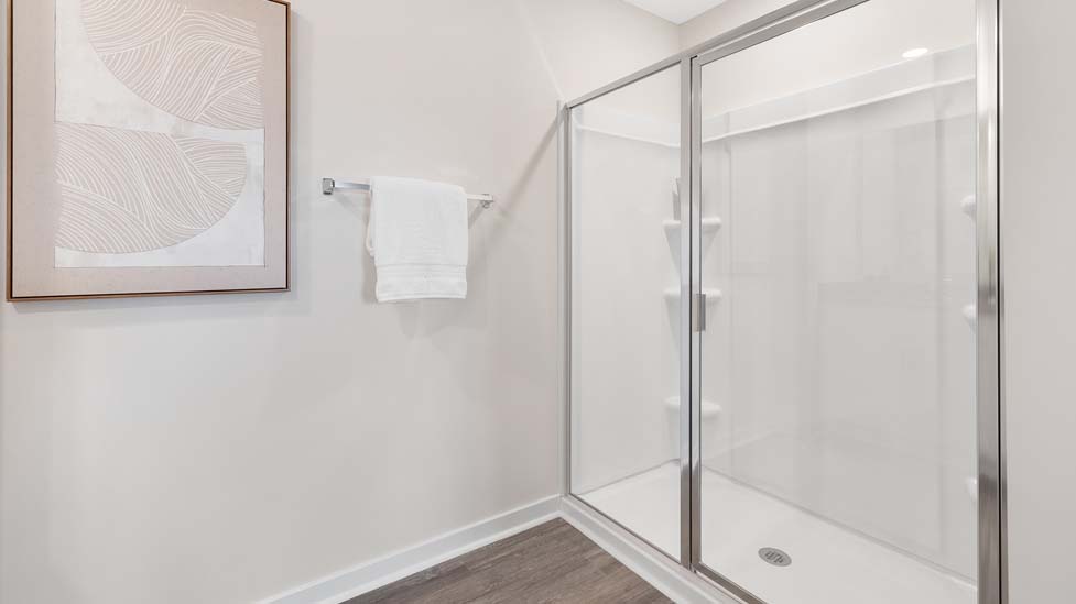 Primary bathroom with double sinks, white cabinets and counters