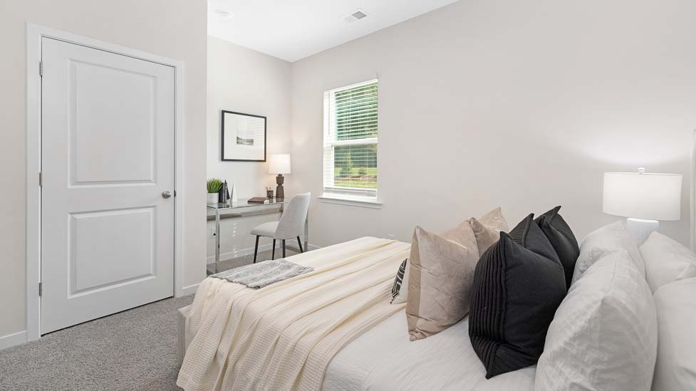 Carpeted bedroom with large window