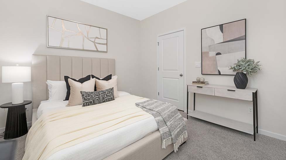 Carpeted bedroom with large window