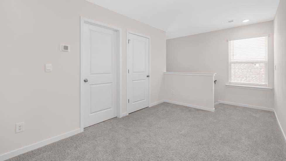Open flex space, carpeted with large window