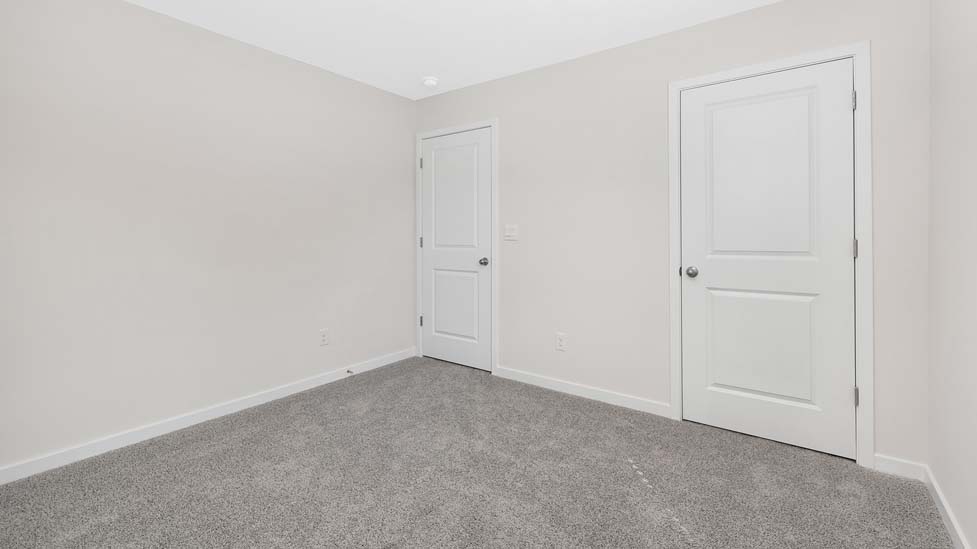 Carpeted bedroom with large window