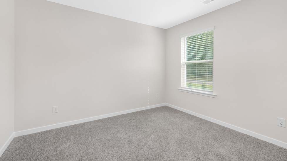 Carpeted bedroom with large window