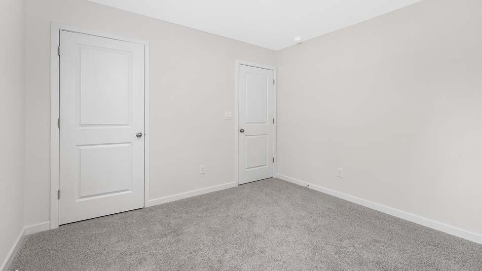 Carpeted bedroom with large window