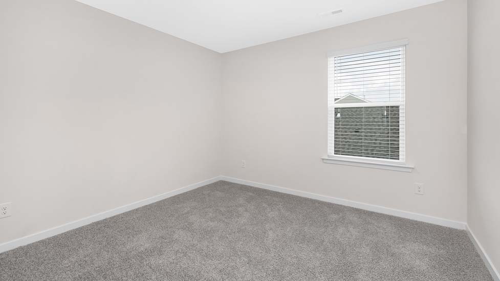 Carpeted bedroom with large window