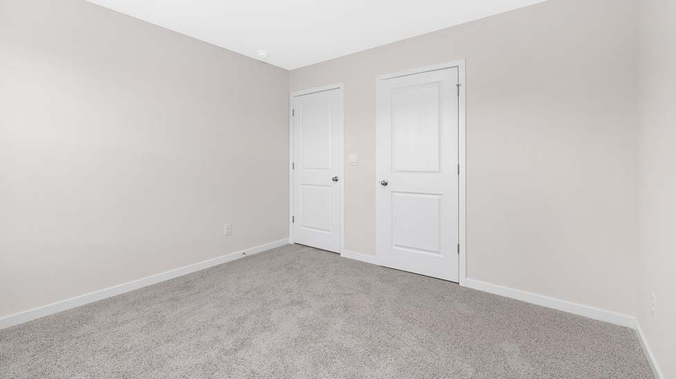 Carpeted bedroom with large window