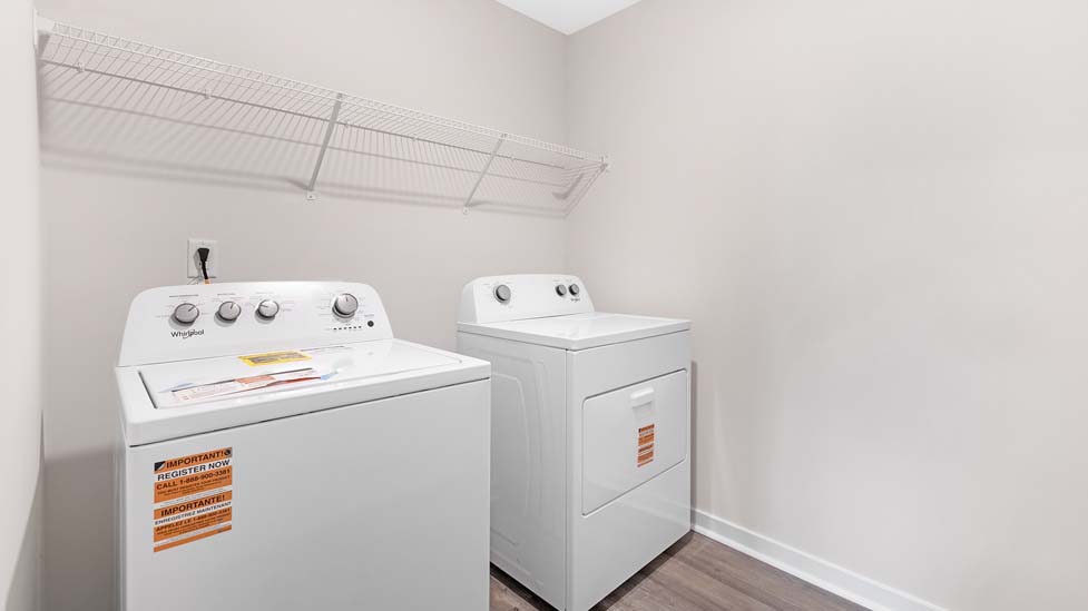 Laundry room with storage hanging racks above machines