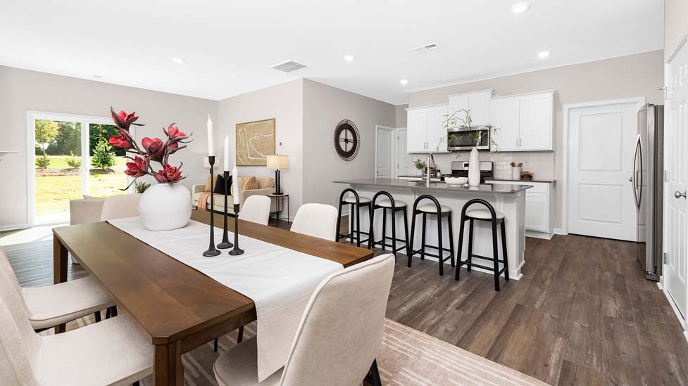 Kitchen and island with white cabinets, subway tile backsplash, and stainless steel appliances