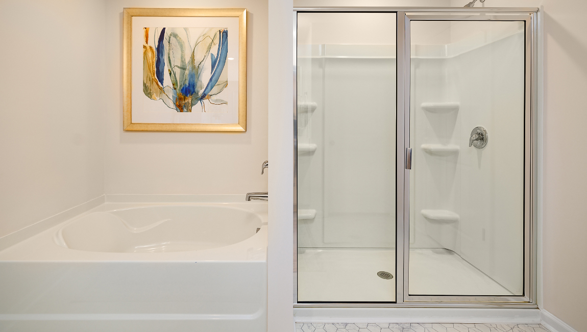 Primary bathroom with double sinks, white cabinets and counters