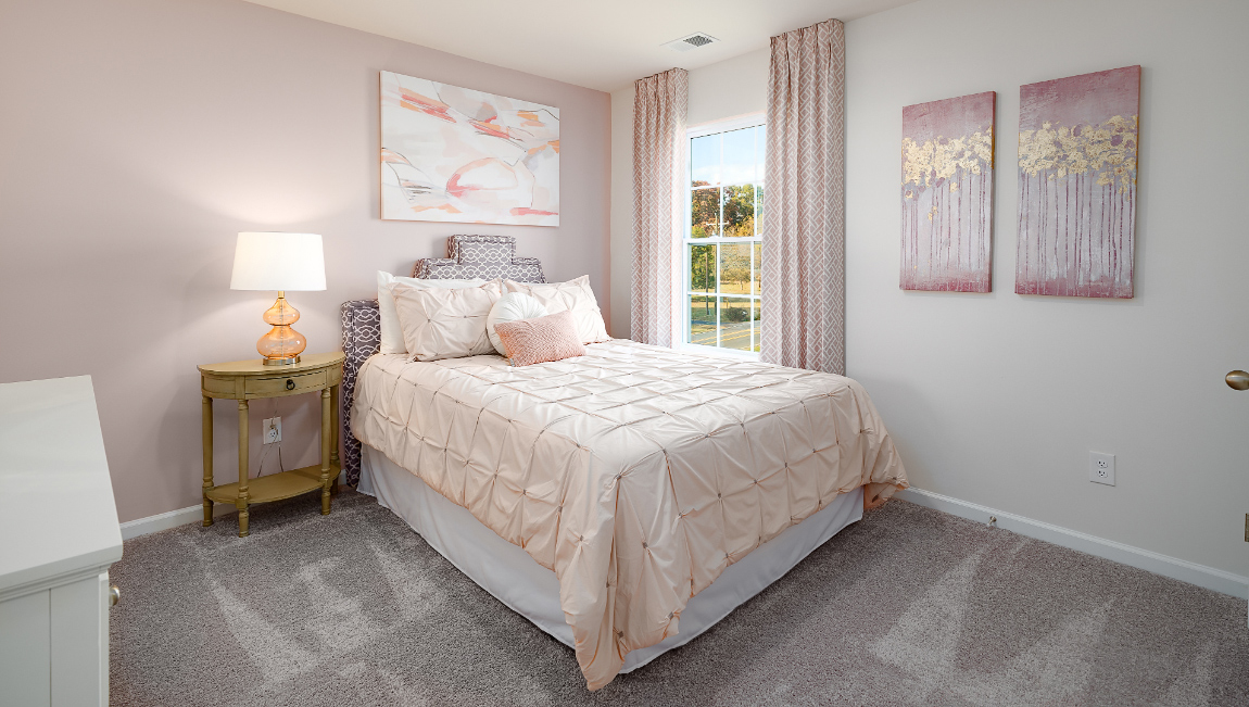 Carpeted bedroom with small window