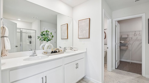 Primary bathroom with double sink vanity and standing shower. New Home in Charlotte, North Carolina