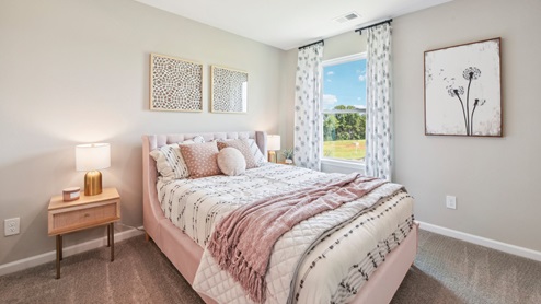 Carpeted bedroom with small window. New Home in Charlotte, North Carolina