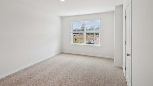 Carpeted bedroom with large window