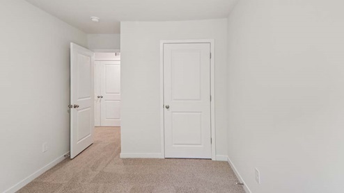 Carpeted bedroom with large window
