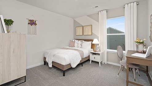Carpeted bedroom with large windows