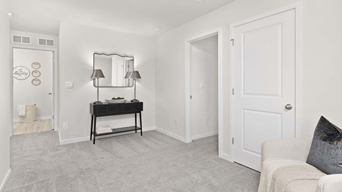 Carpeted bedroom with large windows