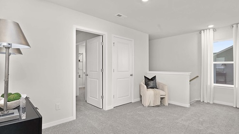 Carpeted bedroom with large windows