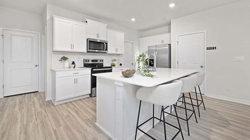 Kitchen and island with stainless steel appliances
