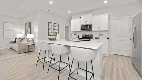 Kitchen and island with stainless steel appliances
