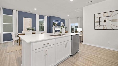 Kitchen and island with stainless steel appliances
