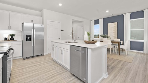 Kitchen and island with stainless steel appliances