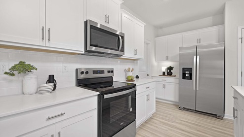 Kitchen and island with stainless steel appliances