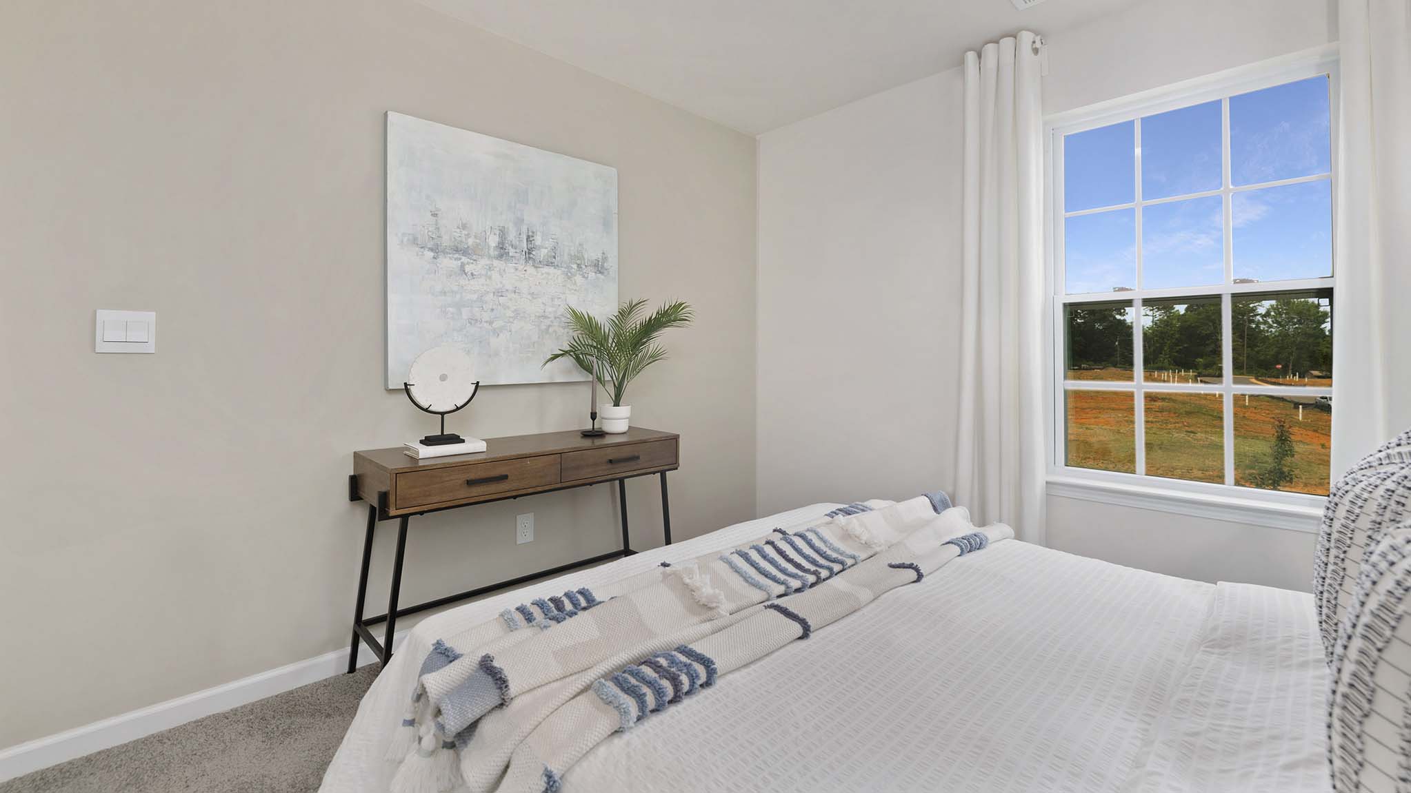 Carpeted bedroom with windows