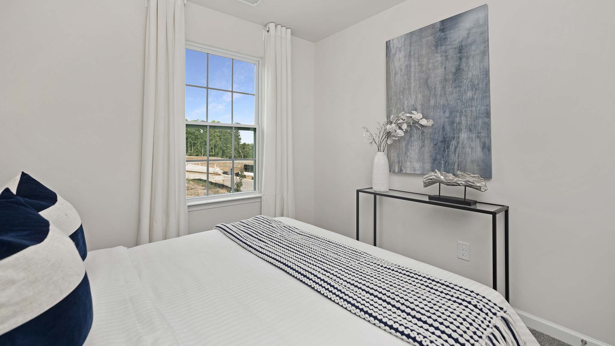 Carpeted bedroom with windows