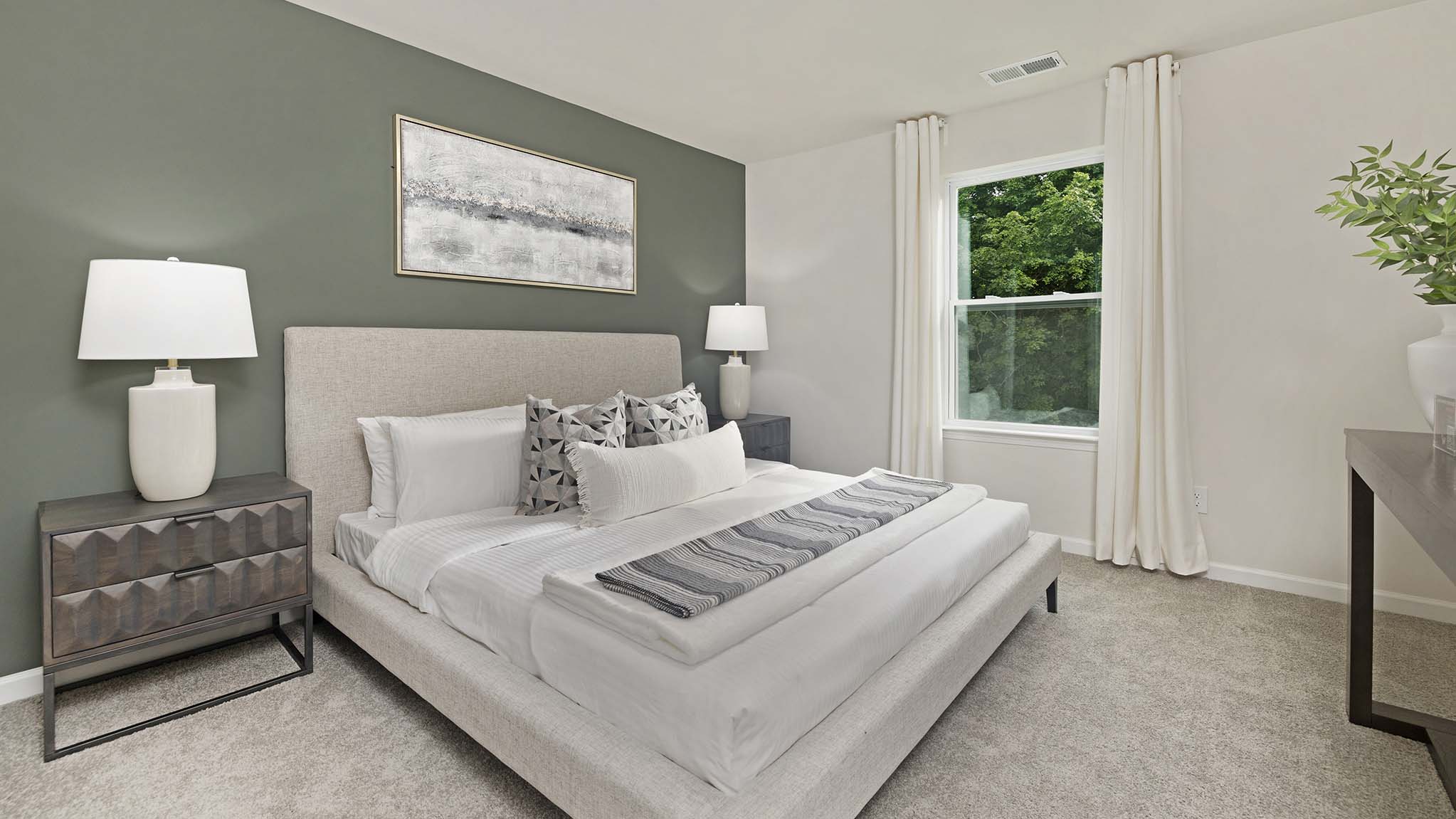 Carpeted bedroom with windows