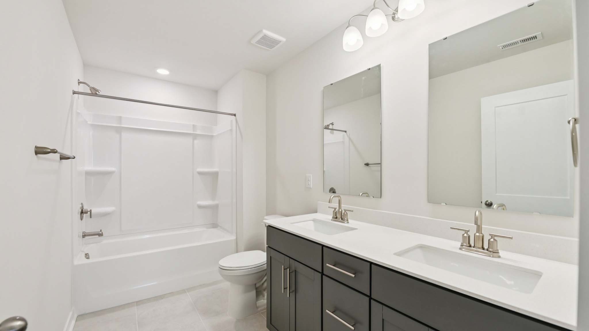 Bathroom with double sinks and tub shower