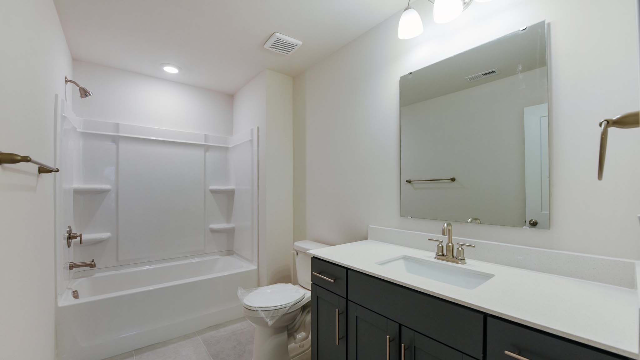Bathroom with double sinks and tub shower