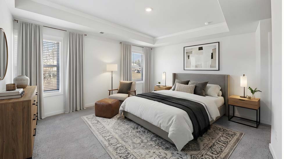 Primary carpeted bedroom with windows