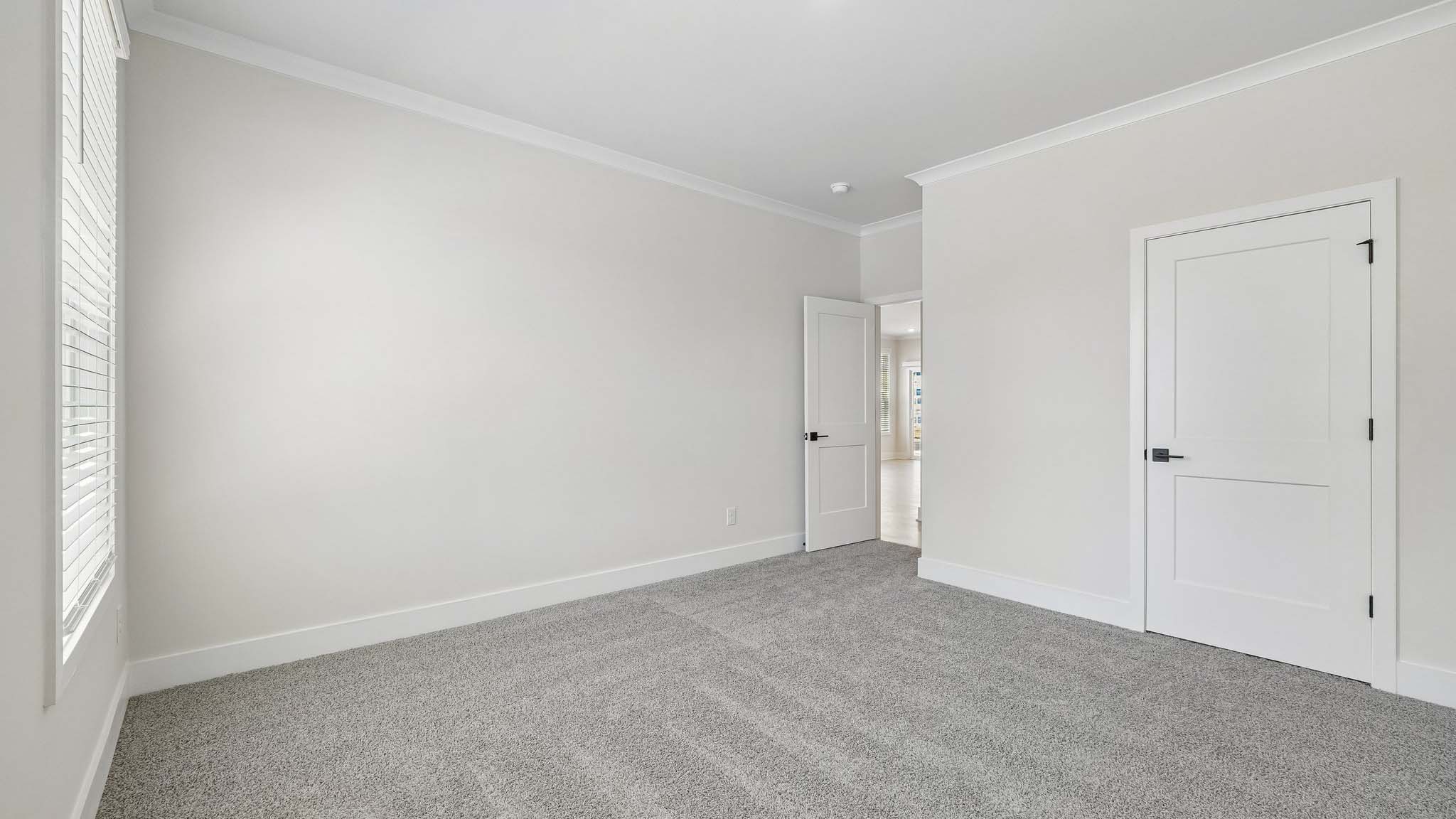 Carpeted bedroom with windows